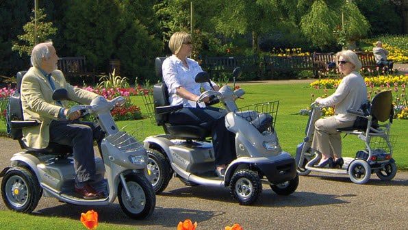 Friends and family helping with a mobility scooter