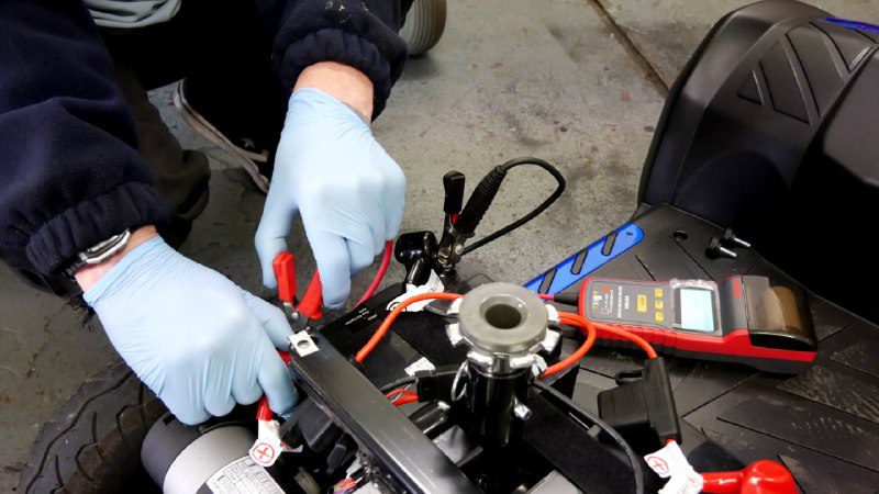 Technician performing an in-home scooter repair