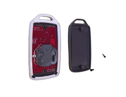 Inserting a tool into the slot on the side of the EV Rider TeQno key fob