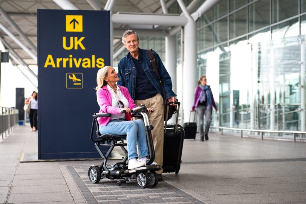 Traveler arriving at an airport with a mobility scooter