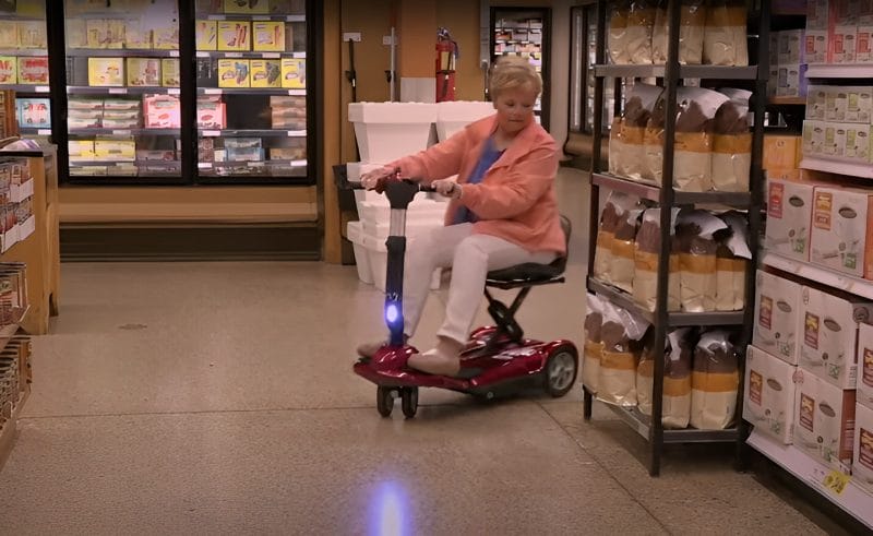 Auto-folding mobility scooter maneuvering through a tight space