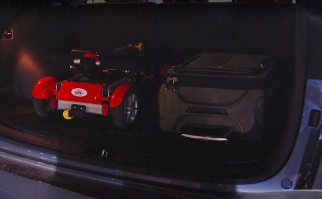 Folded mobility scooter fitting into a compact storage space