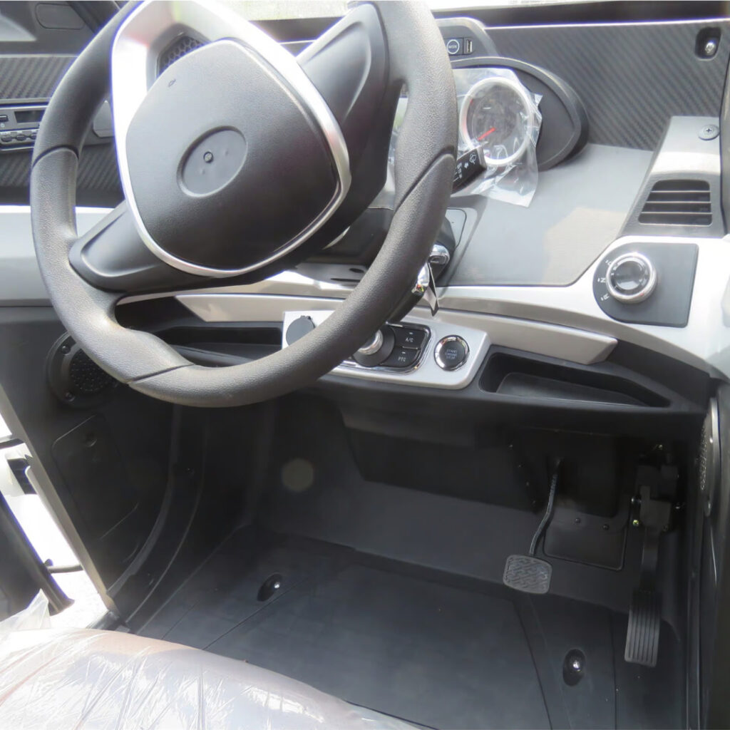 Green Transporter Electric Delivery Cargo Mini Truck steering wheel close up view