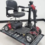 Pride Go Go travel scooter loaded and strapped on the US208 platform lift