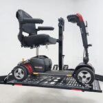 Side view of a mobility scooter secured on the raised US208 electric lift platform