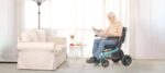 Senior man reading a newspaper while seated in the Robooter E40