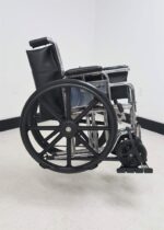 Folding manual wheelchair secured on the Tote Model 003 carrier side view