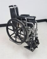 Folding wheelchair loaded and secured on the Tilt N Tote Model 001 carrier