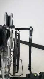 Close up of the Tote Model 003 hold down arm and cam buckle strap on a folded chair