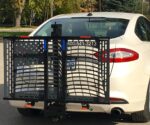 US208 Patriotic Electric Lift mounted on the hitch of a sedan in stowaway position